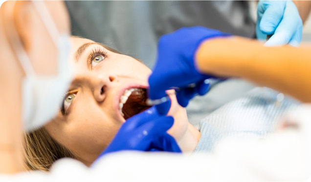 A woman receiving emergency dental care with a focus on comfort and attentive service.