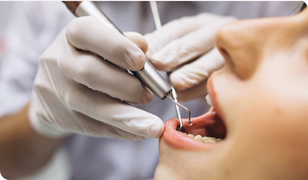 Dental Expert Performing Dental Implants Treatment On A Patient With The Equipment