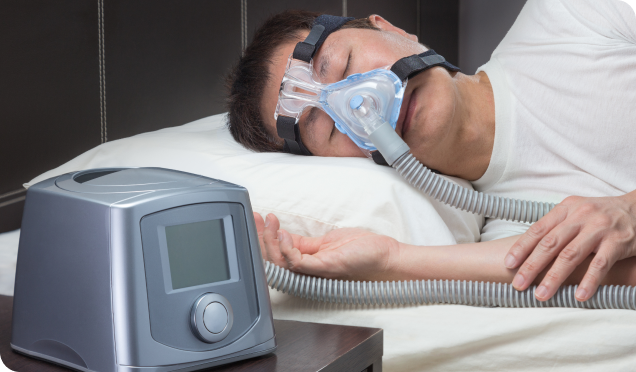 Man With Sleep Apnea Peacefully Sleeping With The Assistance Of A CPAP Device