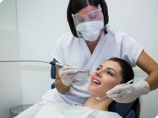 Doctor performing restorative treatment to a patient - Restorative treatment available at Living Water Dentistry in Surrey, BC